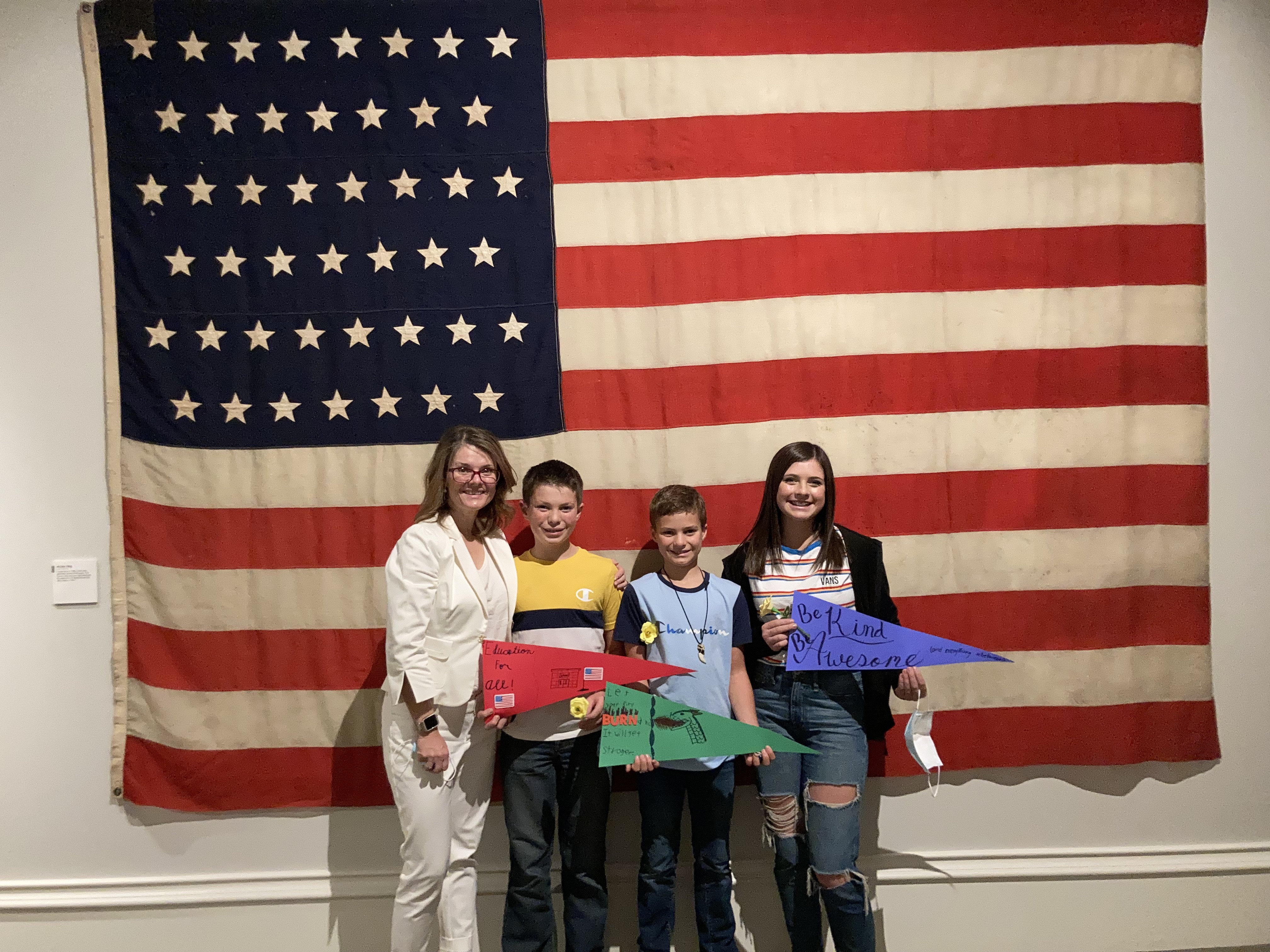 Kara with students in front of American flag
